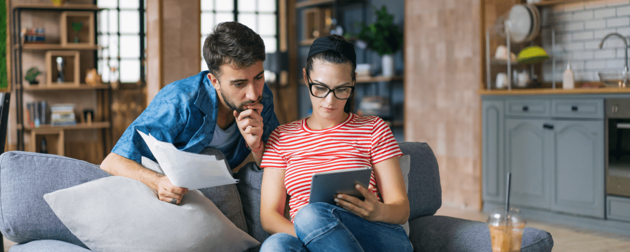 A couple reviewing the cost of solar panel removal and reinstallation