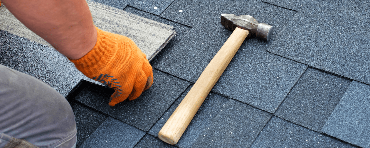 Roofer installing new shingles after solar panel removal