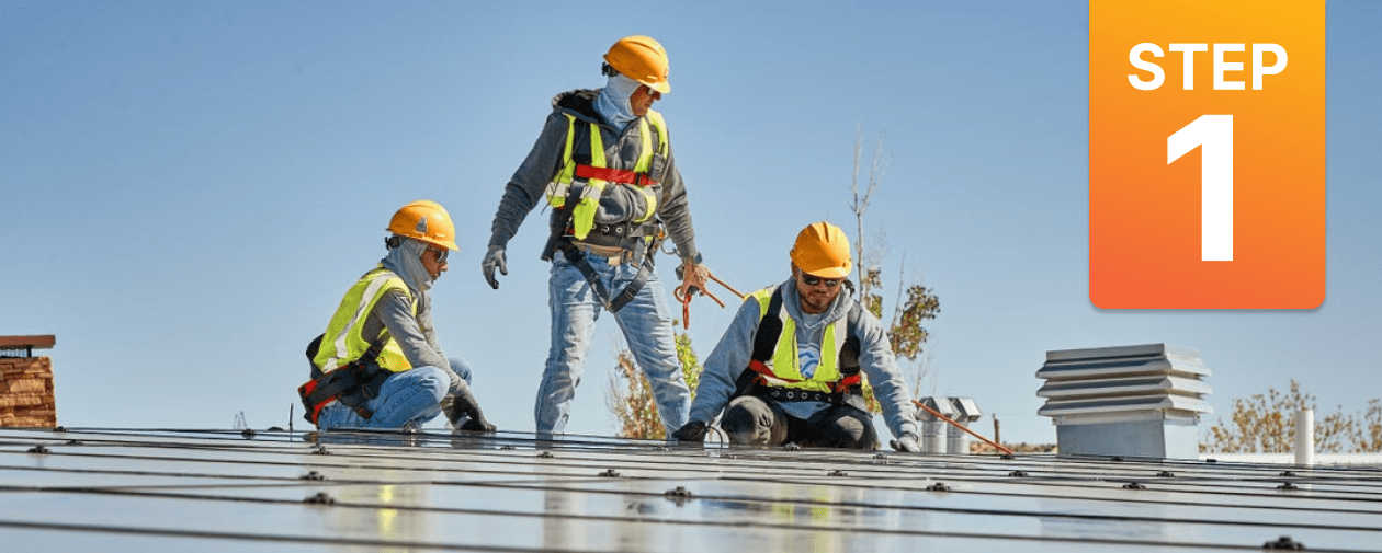 Contractors installing Solar panels on a school