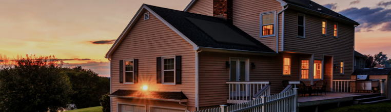 house with solar panels at dusk